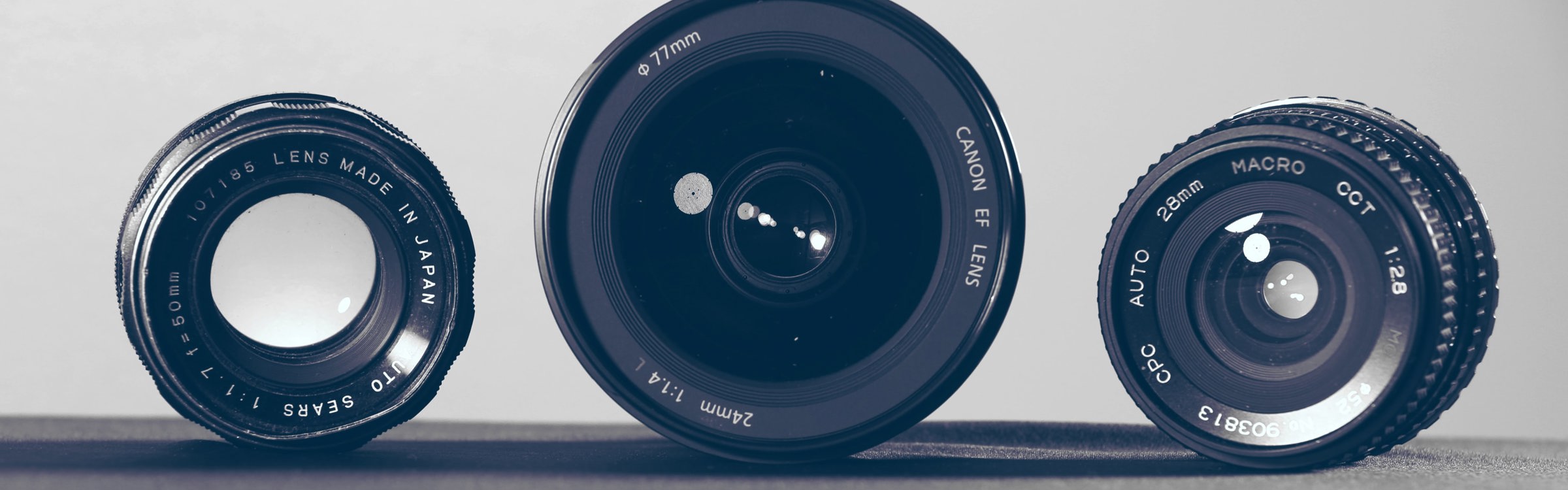 Three camera lenses of varying sizes